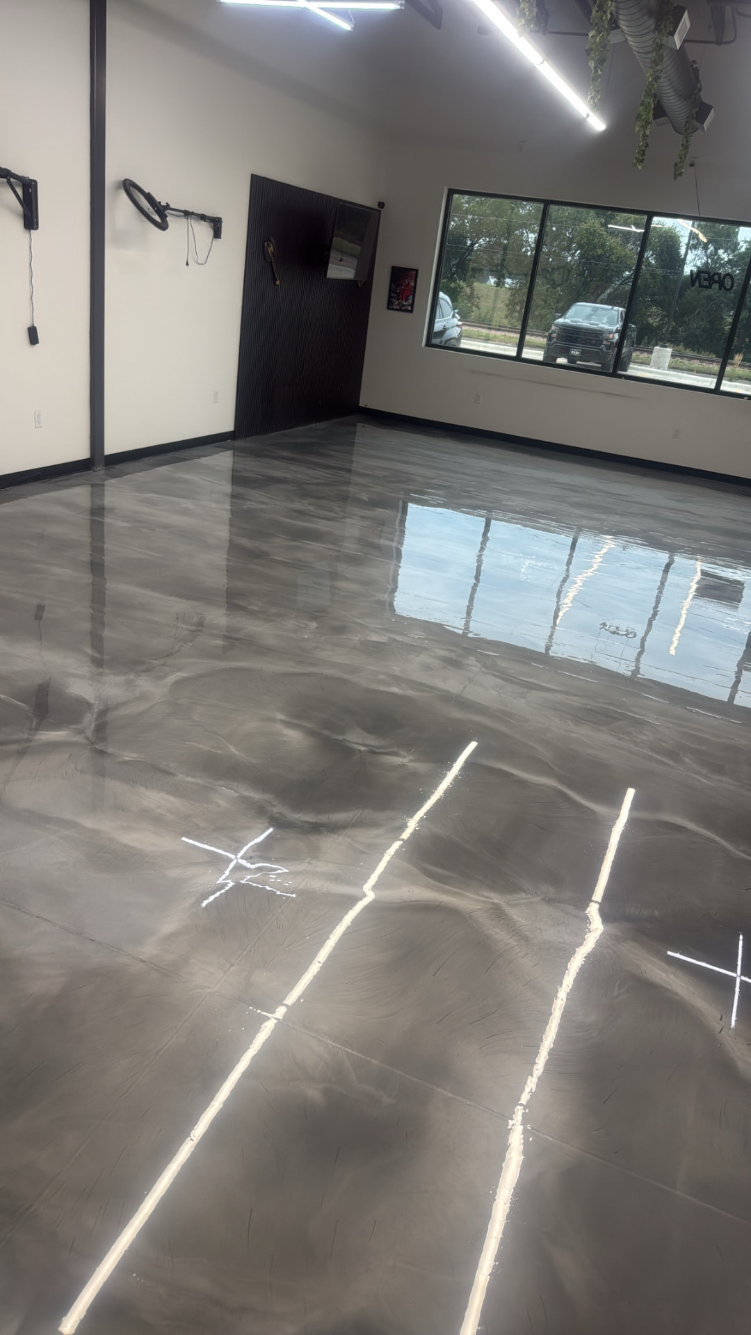 Gray and charcoal metallic epoxy floor with high-gloss reflective finish