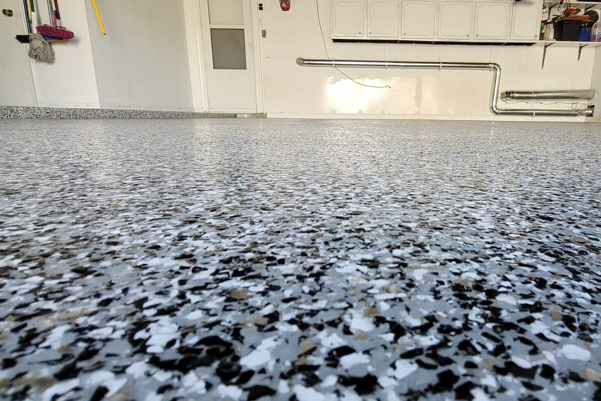 Flake Flooring floor coating — Gray, black and white flake epoxy garage floor with coved base